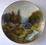 Painted porcelain plate with a hunter and dog
