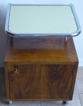 Bedside table made of bent tubes and wooden cabinet