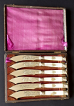 Silver plated knives with mother of pearl, mascarons, shield with monogram