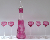 Carafe and five tall glasses, clear and pink glass