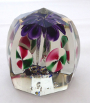 Glass paperweight with purple flower