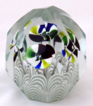 Glass paperweight with striped funnel-shaped flowers
