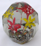Glass paperweight, two yellow and two red flowers