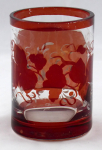 Small glass with medallion and vine leaves