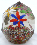 Glass paperweight with coloured flowers and facets
