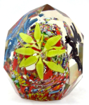 Colourful paperweight with three flowers in a basket