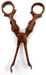 Wooden tongs with figural carving